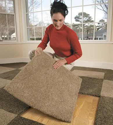 Carpet tiles being installed indoors
